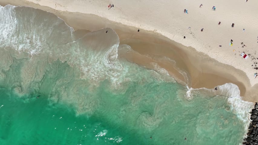 Aerial Image of CITY BEACH WAVES CRASHING TOP DOWN