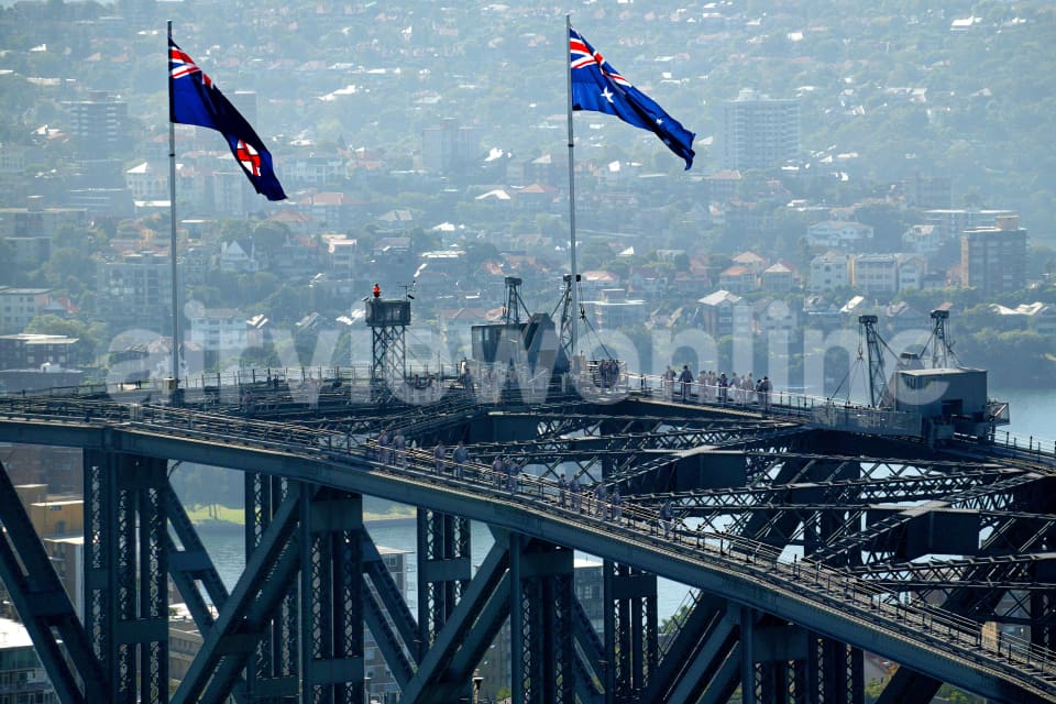 Aerial Image of Australian & New South Wales flags fluttering atop the Sydney Harbour Bridge