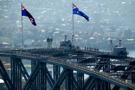 Aerial Image of AUSTRALIAN & NEW SOUTH WALES FLAGS FLUTTERING ATOP THE SYDNEY HARBOUR BRIDGE