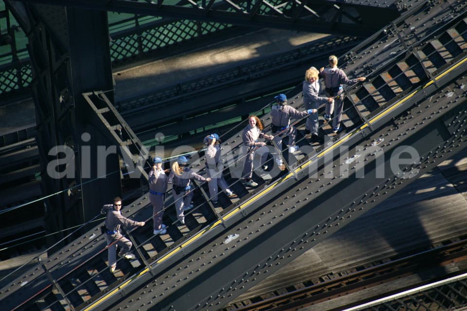 Aerial Image of Bridgeclimbers hold tight to The Sydney Harbour Bridge